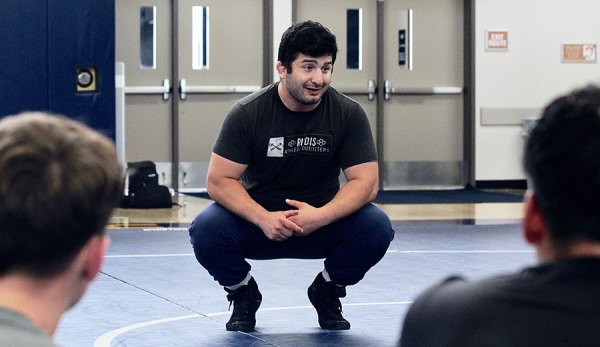 Isaiah Martinez talks to a group of student wrestlers at West Hills College Lemoore on Saturday.